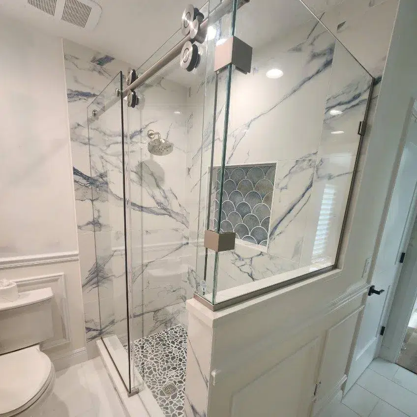 Euro Glide sliding glass shower doors and enclosure installed by Lemon Bay Glass in a modern Florida bathroom