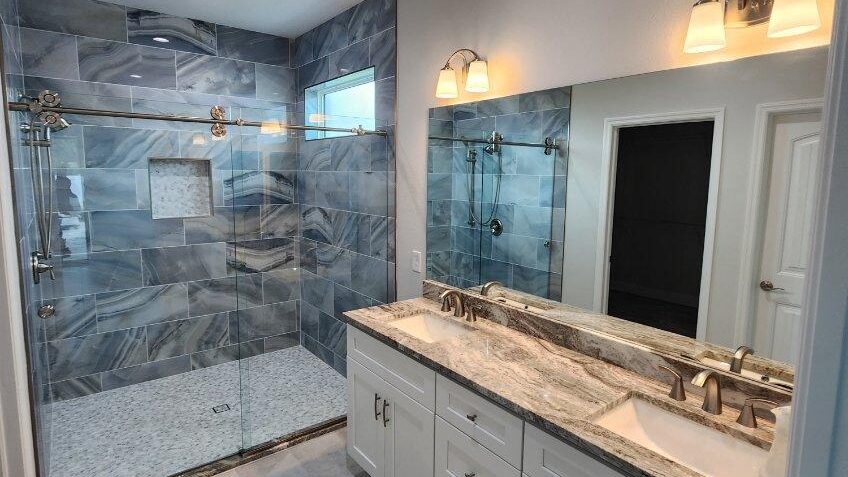 Frameless Vanity Mirror over Dual Sink in Coastal Bathroom. Mirror Installation by Lemon Bay Glass in Southwest Florida Home