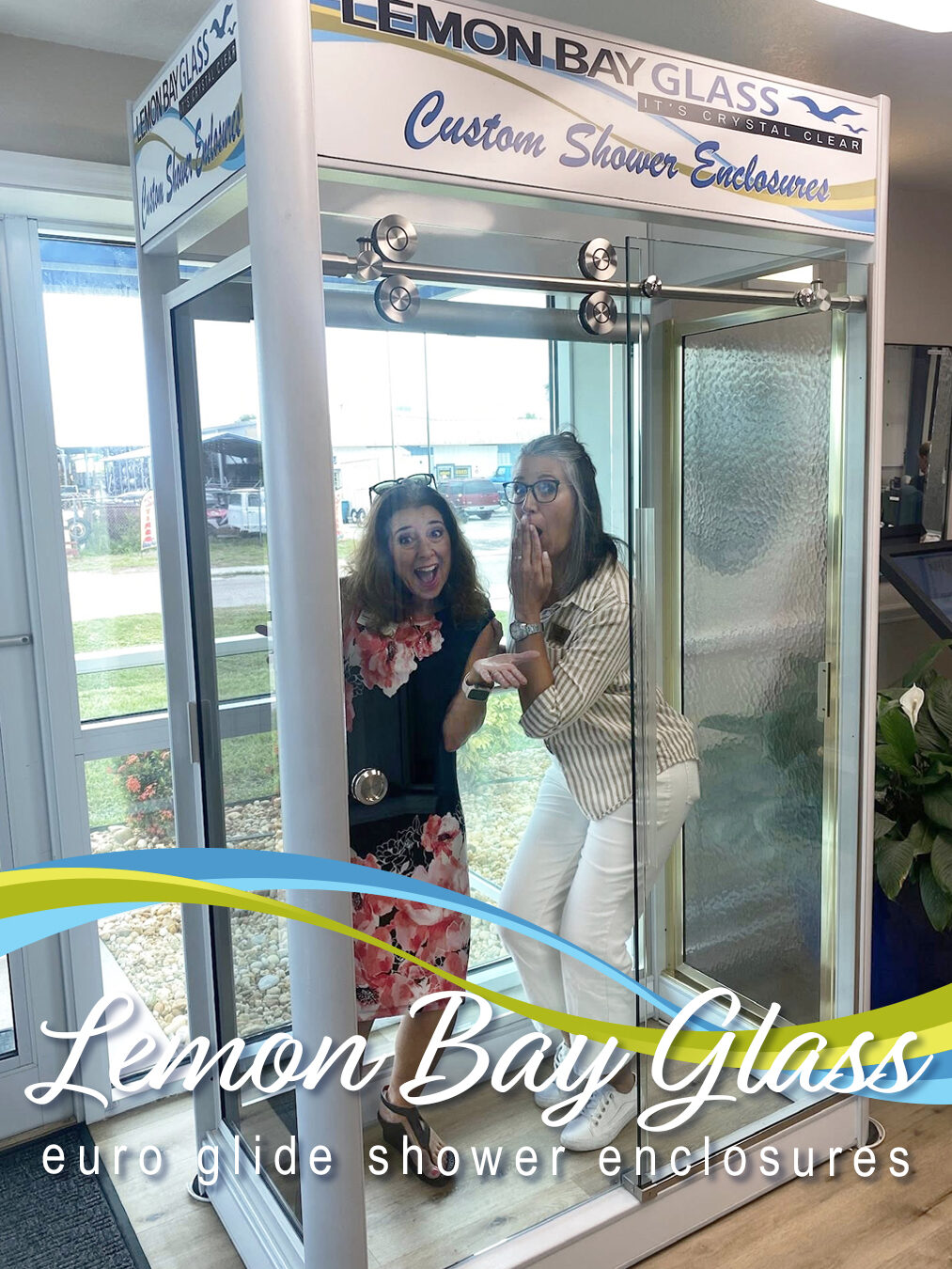 Lemon Bay Glass showroom Englewood FL customers inside custom shower enclosure display interacting with sliding glass door system