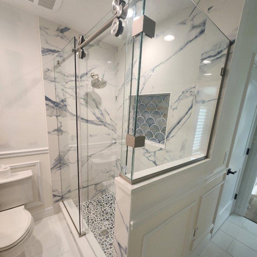 Frameless shower doors use thicker tempered glass with minimal hardware to create a clean, open appearance. Euro Glide shower enclosure professionally intalled by Lemon Bay Glass Englewood FL.  