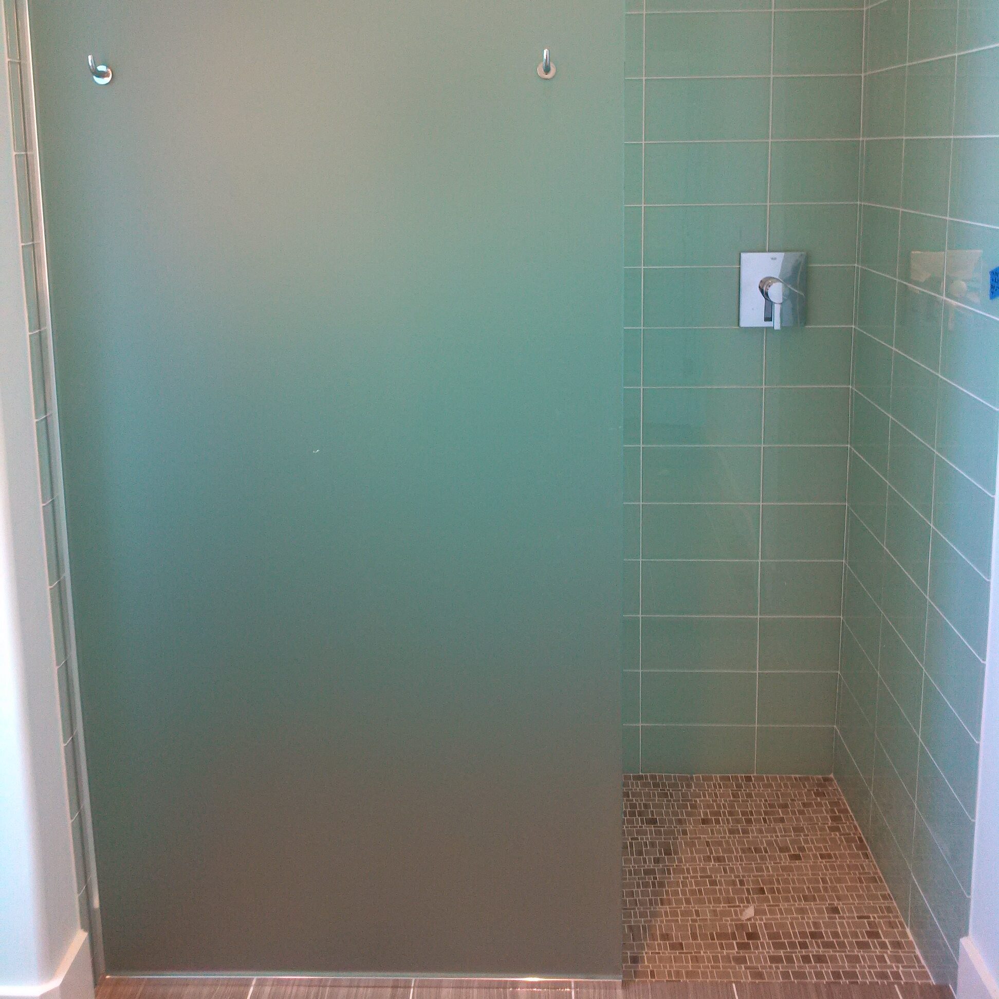 Frameless frosted glass panel. An effortless walkin shower enclosure installed by Lemon Bay Glass Englewood FL.  